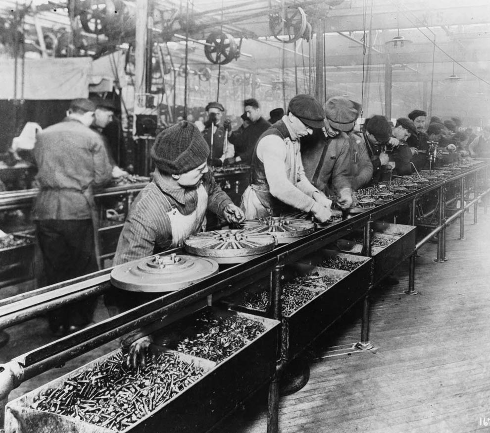 Workers on an assembly line, similar to a headless CMS. 