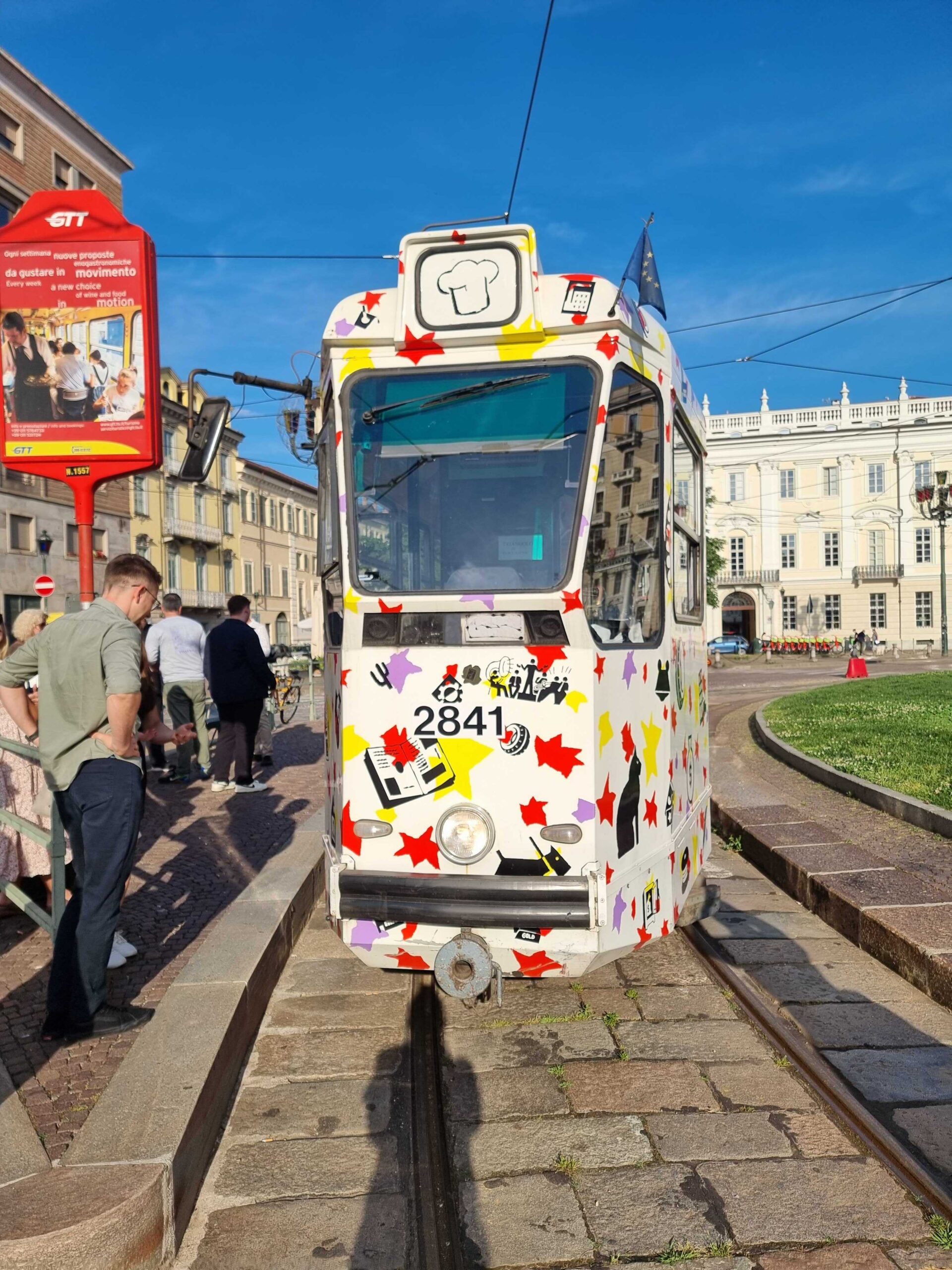 A specially decorated tram with red, yellow and purple stars.