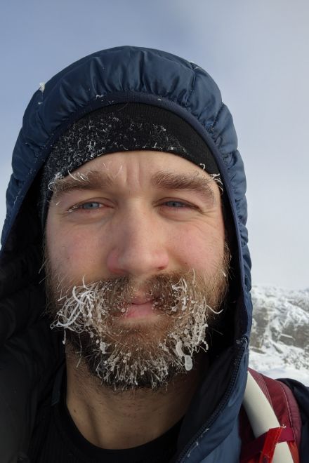 Selfie of Landon on a mountain with a frozen eyebrows and beard