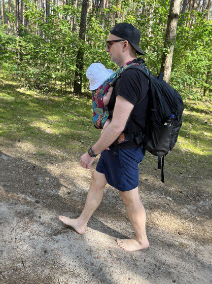 Marcin and his daughter taking a walk in a forest